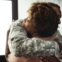 military family hug four