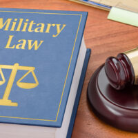 A law book with a gavel – Military law
