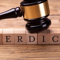 Gavel Over Wooden Blocks With Text Verdict