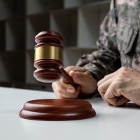 Hand of soldier holding gavel military attorneys
